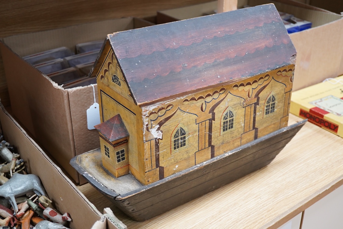 A 19th century German Erzgebirge pine painted Noah's Ark together with a good quantity of carved and painted wooden animals, the ark decorated with trompe l’oeil architectural features, geometric patterns, Gothic windows